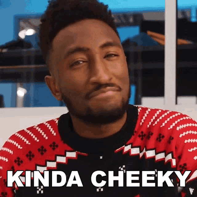 a man wearing a red and black sweater with kinda cheeky written below him