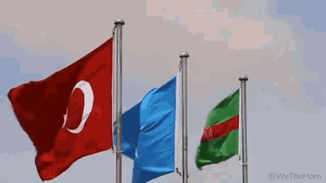 three flags are waving in the wind with the words we the horn in the corner