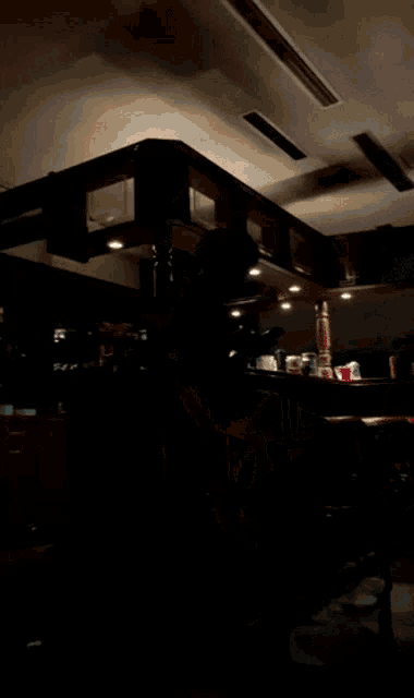 a man sitting at a bar giving a thumbs up