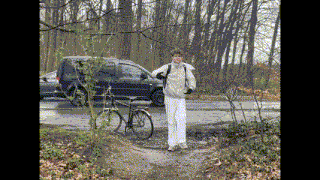 a woman is standing next to a bicycle in front of a van