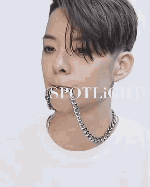 a close up of a person 's face with the word spotlight behind him