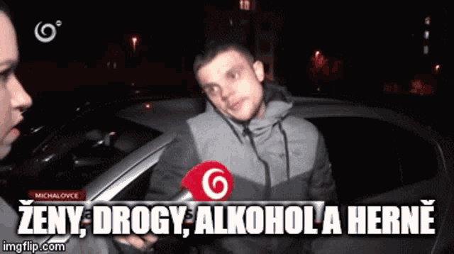 a man talking into a microphone with the words zeny drogy alkohola herne