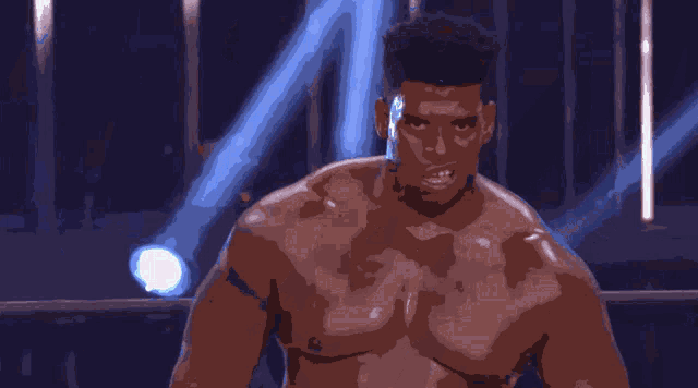 a man without a shirt is standing in a dark room