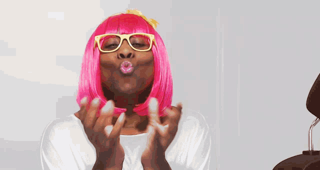 a woman wearing a pink wig and glasses is screaming