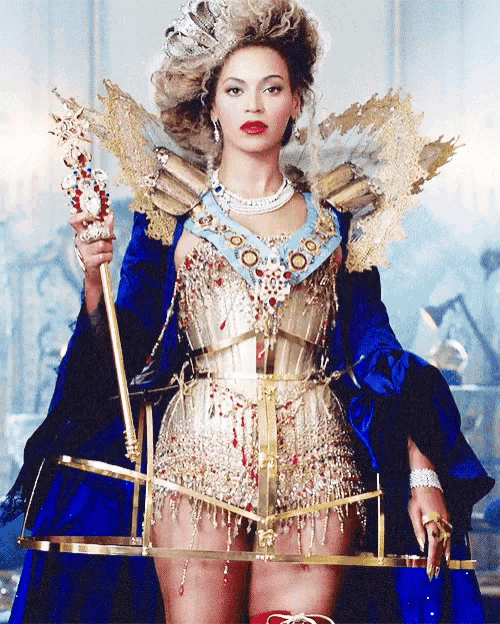 a woman in a blue dress is holding a crown