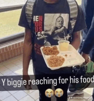 a man wearing a shirt that says ' biggie reaching for his food '