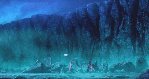 a couple of people standing in front of a rock wall with bubbles coming out of it