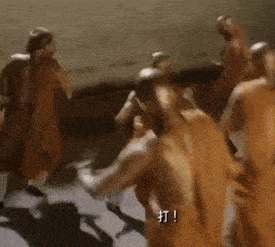 a group of people are dancing in a room with chinese writing on the bottom right