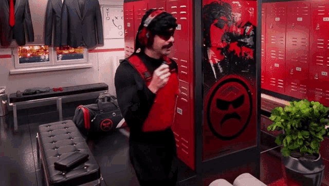 a man standing in a locker room with a black and red logo on the wall that says hc