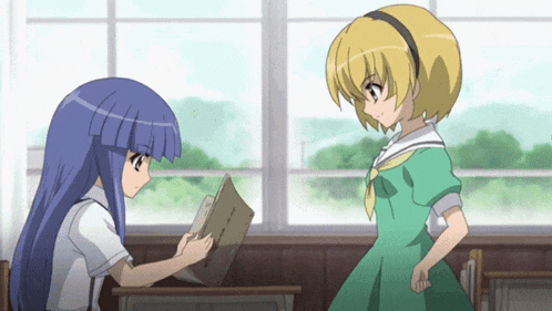 a girl in a green dress is standing next to a girl in a blue dress