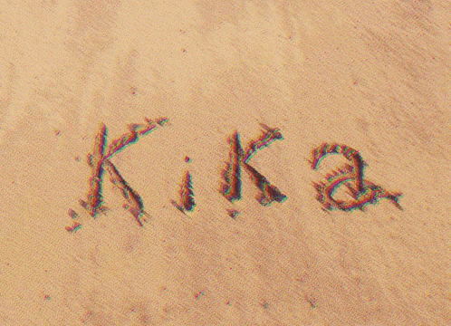 the name kika is written in the sand on a beach