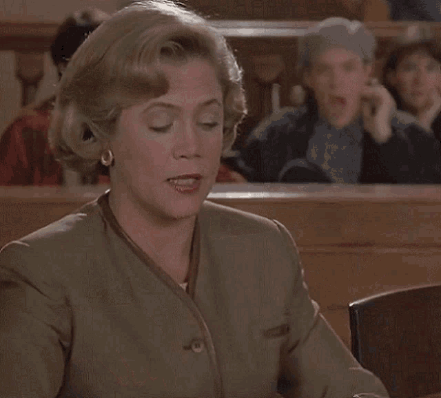a woman in a courtroom holding a magazine that says chicks on girls