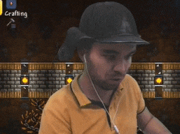 a man wearing a hat and ear buds stands in front of a screen that says call of duty