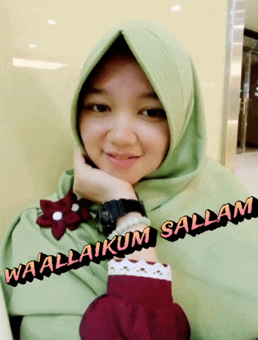 a woman wearing a green hijab with the words wa allaikum salam written on the bottom