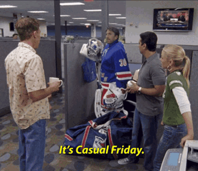 a man in a hockey uniform says it 's casual friday while standing next to a woman