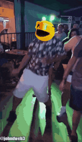 a pixelated image of a man dancing with a pac man head on his head