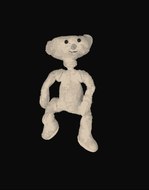 a white teddy bear with a blue nose is sitting on a black surface