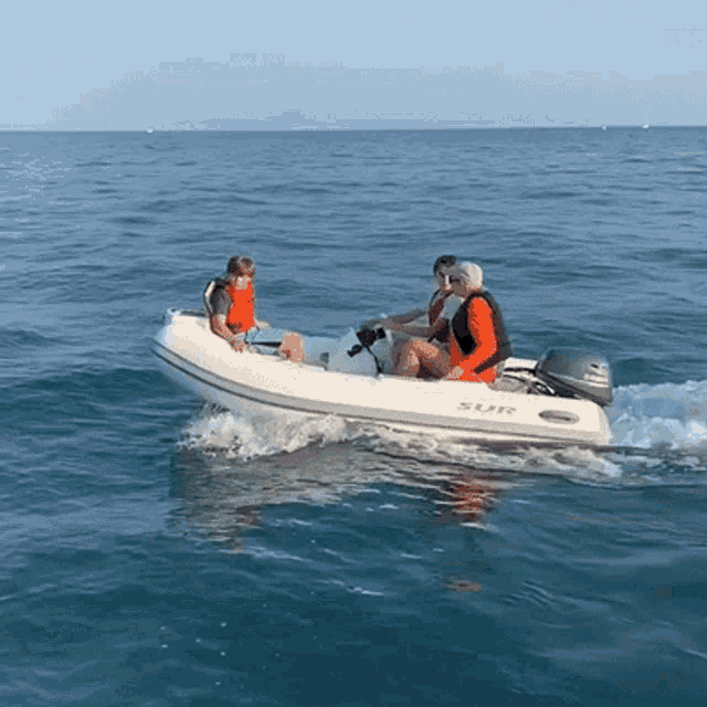 a group of people are in a boat that says sur on it