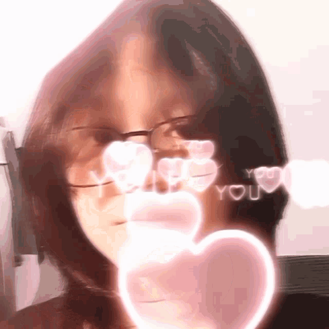 a girl wearing glasses has hearts in her eyes and the words " i love you "