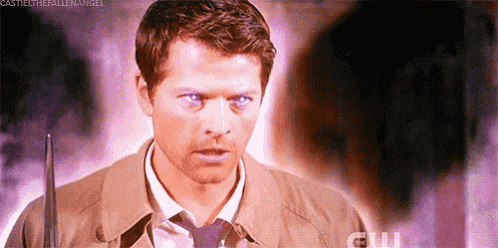 a man with purple eyes is holding a sword and looking at the camera .