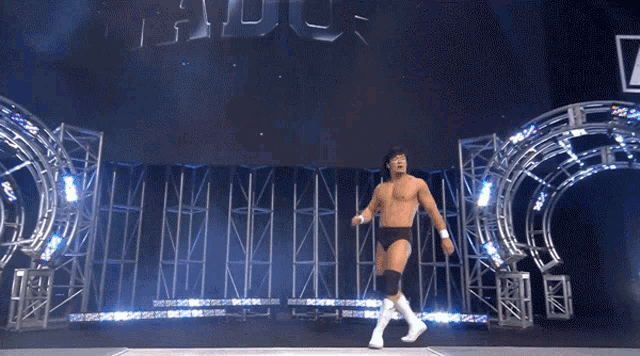 a wrestler is walking through a tunnel with the word havoc on the wall
