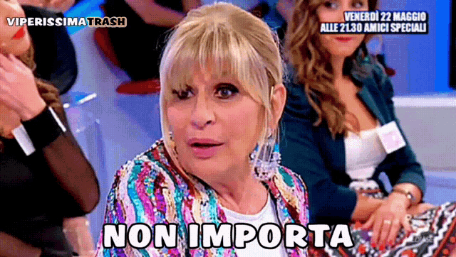 a woman in a sequined jacket says non importa in front of a group of women