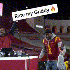a man stands in front of a sign that says rate my griddy on it