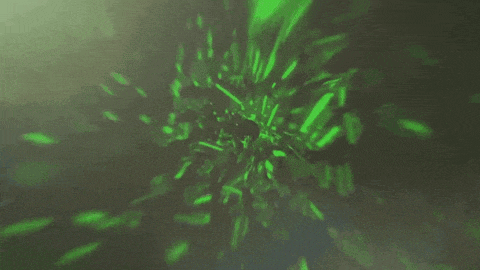 a green light is shining through a hole in a dark background .