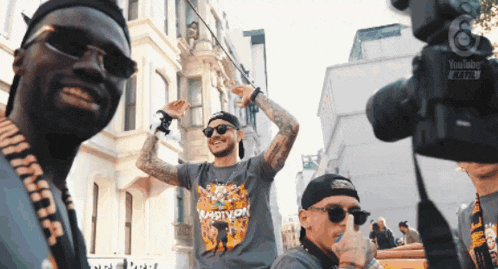 a man wearing a shirt that says ambition is being filmed