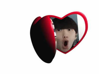 a heart shaped mirror with a woman 's face and a man 's face on it