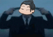 a man in a suit and tie is holding his hands to his ears .