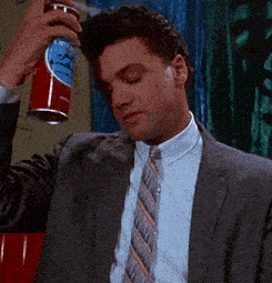 a man in a suit and tie is holding a can of diet coke