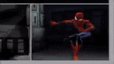 a red spider-man is crawling on the floor in a dark room .