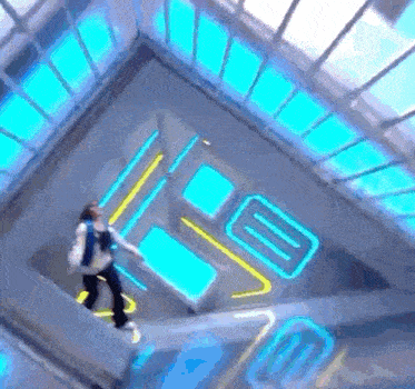 a person is walking down a set of stairs with blue lights on the walls