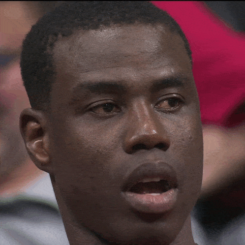 a close up of a man 's face with a tear running down his face