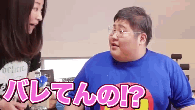a man wearing a blue shirt with the word delicious on it talks to a woman