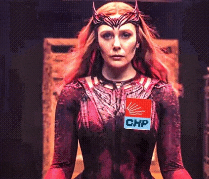 a woman in a red dress with a chip on her chest .