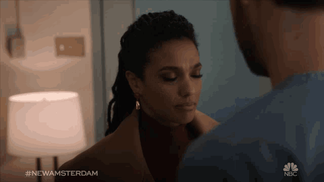 a man and a woman are looking at each other with the hashtag #newamsterdam on the bottom