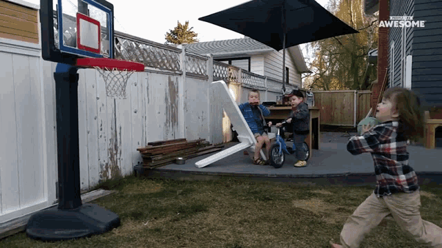 a basketball hoop in a backyard with the word awesome on the bottom right