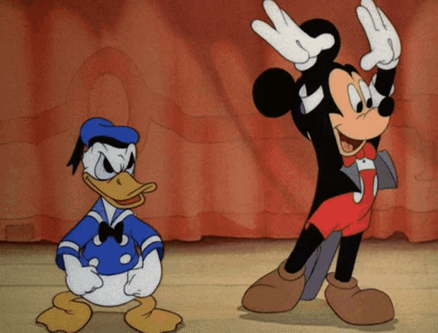 donald duck and mickey mouse are standing next to each other on a stage