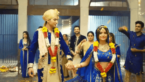 a bride and groom are holding hands while walking down a staircase .