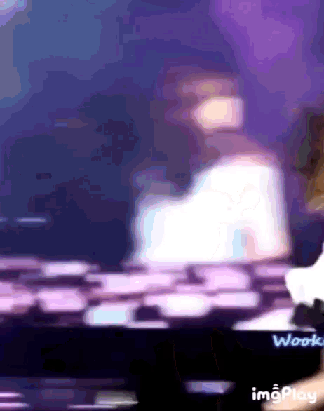 a blurry picture of a person with the word wook on the bottom left