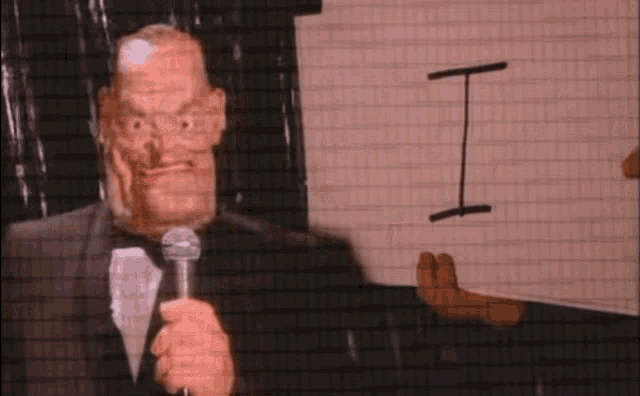 a man in a tuxedo is holding a sign that says - gc