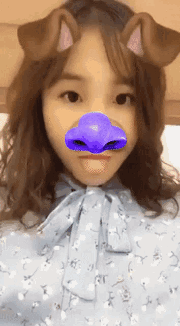 a girl with a purple nose and ears on her head