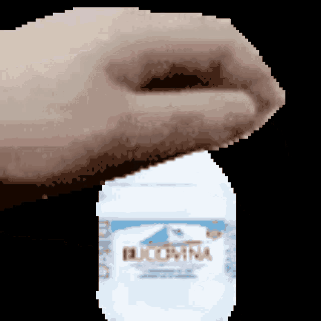 a pixelated image of a person holding a bottle of blue china