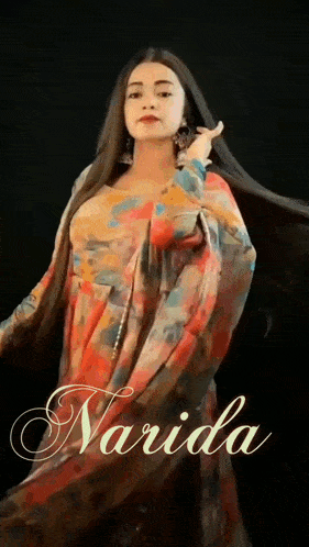 a woman with long hair is wearing a colorful dress with the name navida written on the bottom