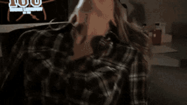 a close up of a woman 's breasts in a plaid shirt