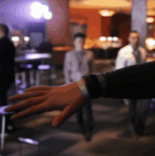 a blurred image of a person 's hand reaching out