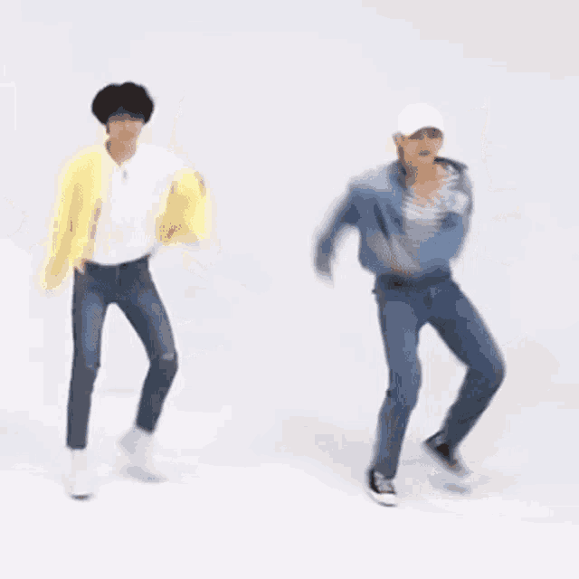 a group of people are dancing in a room .