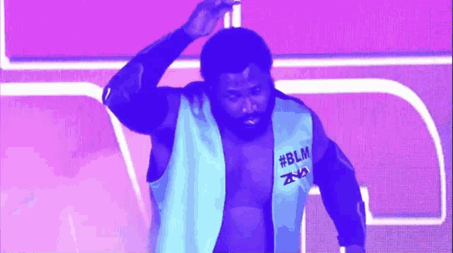 a man wearing a blue vest with #blm on it